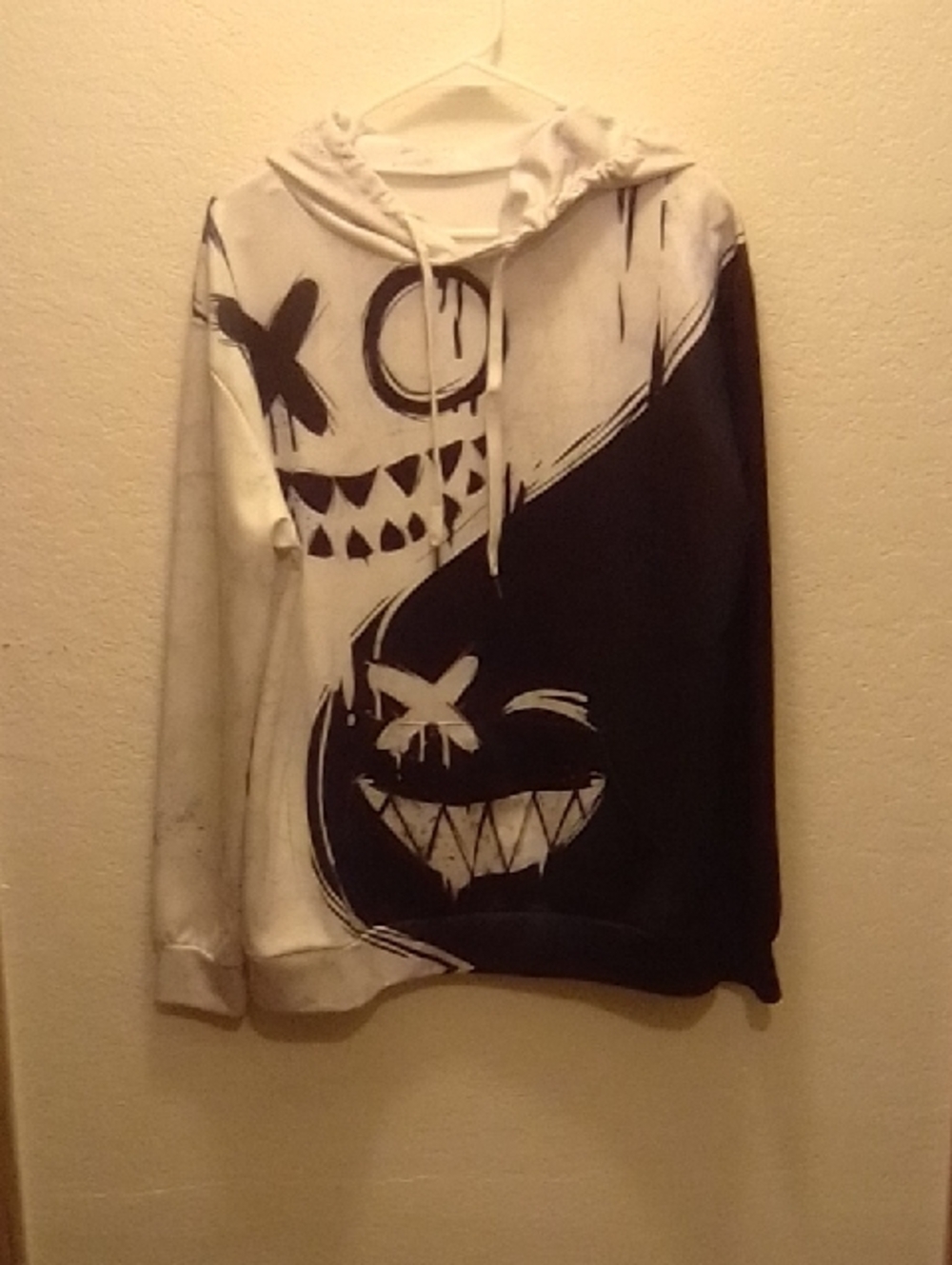 Black and White Graphic Hoodie with Smiling Skull Design